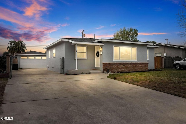 view of front of home with a garage, an outbuilding, and a yard