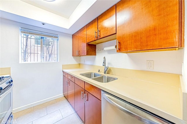 kitchen with sink, light tile patterned flooring, and appliances with stainless steel finishes