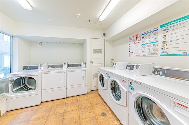 washroom with washer and dryer and light tile patterned floors