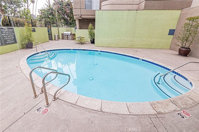 view of swimming pool featuring a patio area