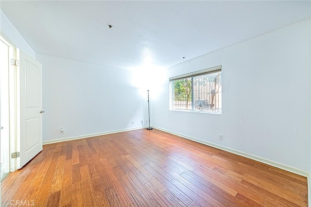 unfurnished room featuring hardwood / wood-style floors