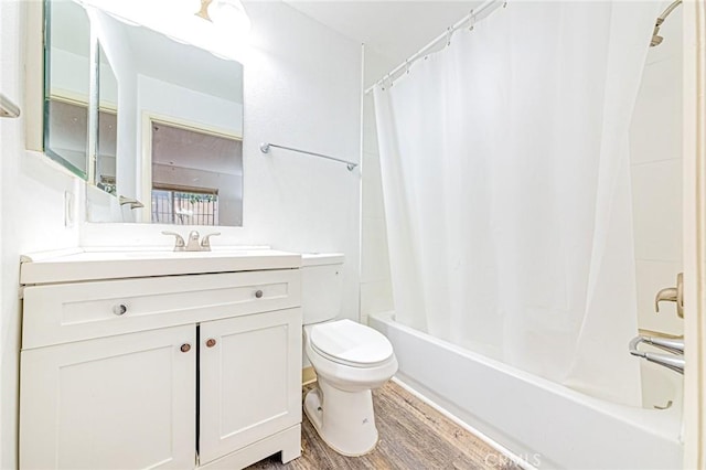 full bathroom featuring hardwood / wood-style floors, vanity, shower / tub combo, and toilet