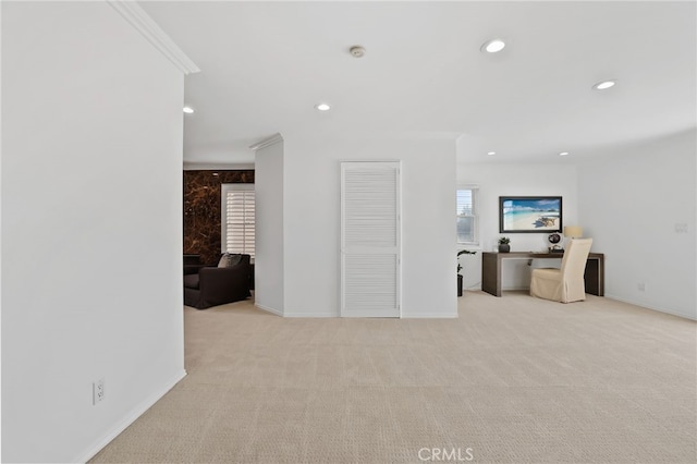 carpeted living room with crown molding