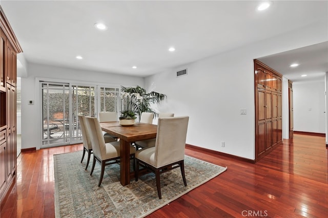 dining space with dark hardwood / wood-style floors