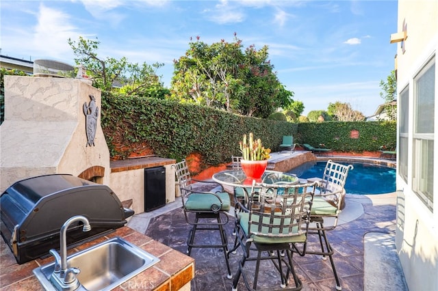 view of patio / terrace featuring a fenced in pool, area for grilling, and grilling area