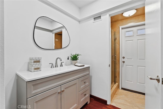 bathroom featuring a shower, wood-type flooring, and vanity