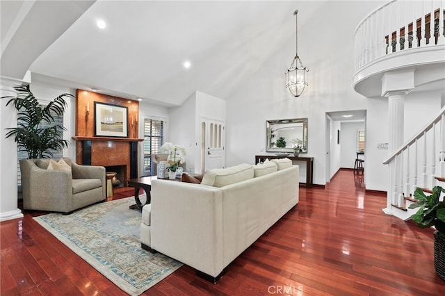 living room featuring high vaulted ceiling, dark hardwood / wood-style floors, and a notable chandelier