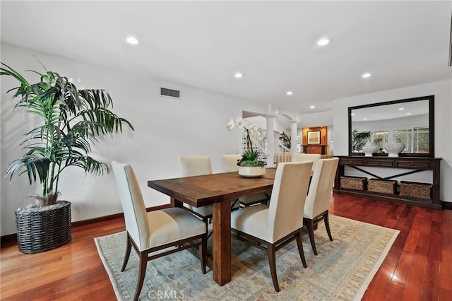 dining space with hardwood / wood-style floors