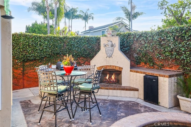 view of patio / terrace featuring an outdoor fireplace