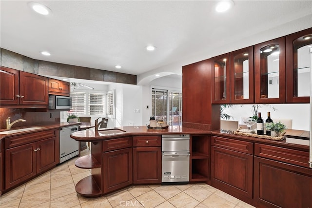 kitchen with appliances with stainless steel finishes, plenty of natural light, and sink