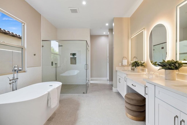 bathroom with vanity and independent shower and bath