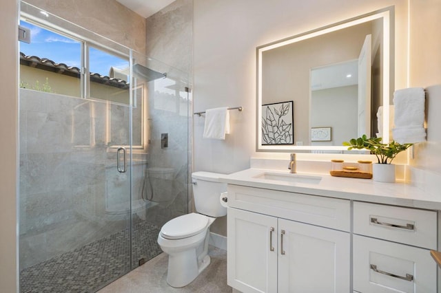 bathroom featuring an enclosed shower, vanity, and toilet