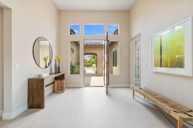 foyer featuring a towering ceiling