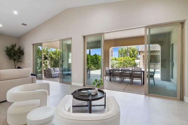 tiled living room with high vaulted ceiling