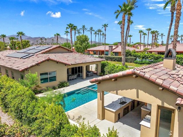 view of swimming pool featuring a mountain view and a patio area