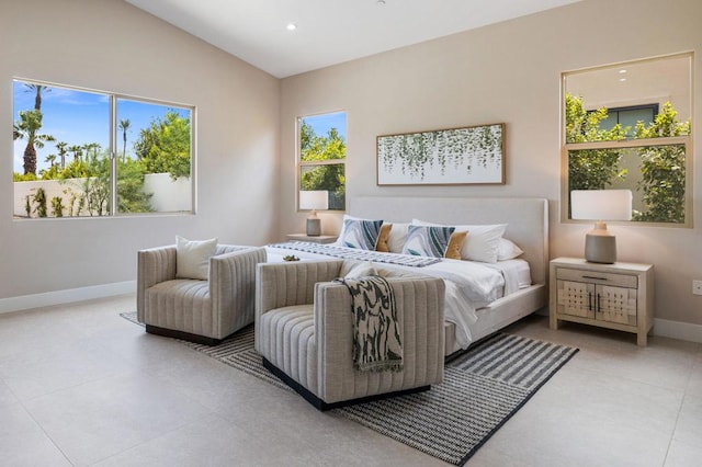 bedroom featuring lofted ceiling and light tile patterned floors