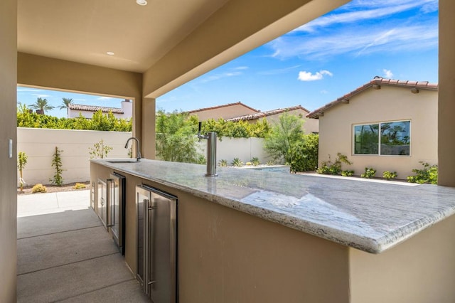 view of patio / terrace with sink and beverage cooler