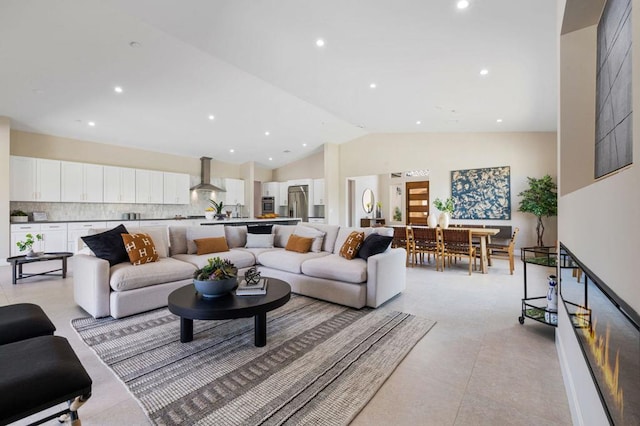 living room featuring high vaulted ceiling