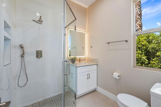 bathroom featuring tile patterned flooring, vanity, an enclosed shower, and toilet