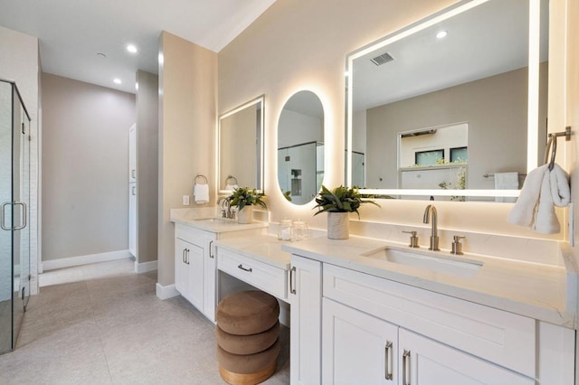 bathroom with tile patterned floors, a shower with door, and vanity