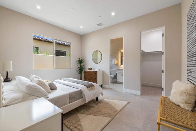 bedroom featuring ensuite bathroom, a spacious closet, and a closet