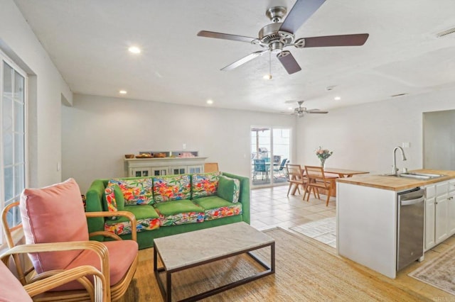 playroom featuring ceiling fan, sink, and light wood-type flooring