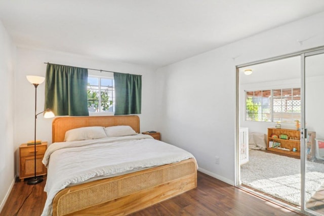 bedroom featuring access to outside, multiple windows, and hardwood / wood-style flooring