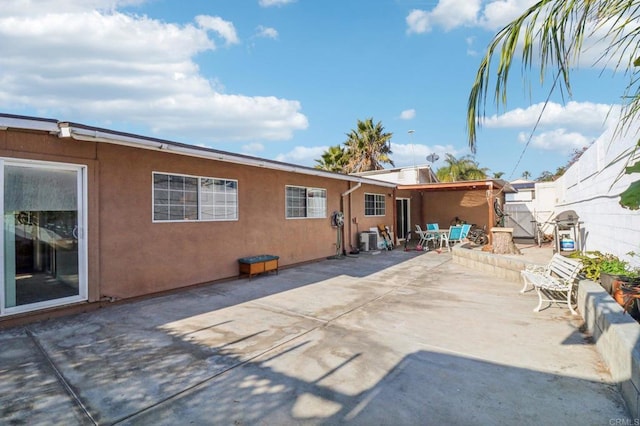 back of property with a patio area and central AC