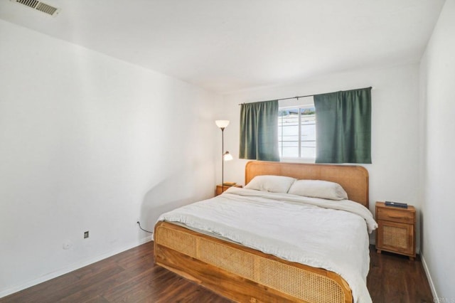 bedroom featuring dark hardwood / wood-style flooring