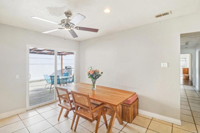 tiled dining space featuring ceiling fan