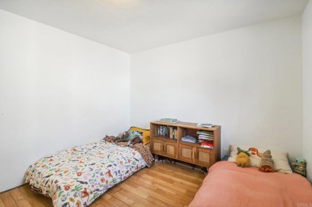 bedroom with hardwood / wood-style floors