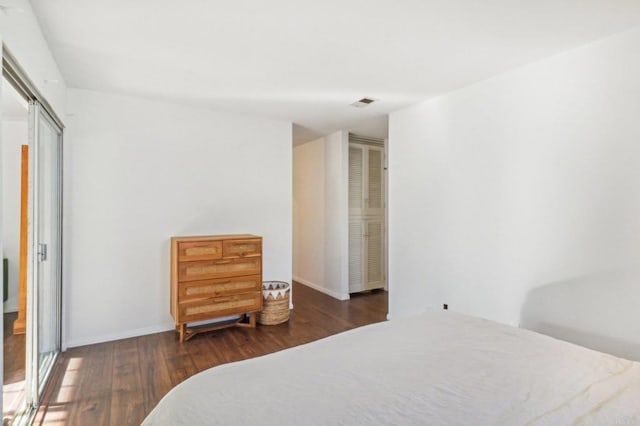 bedroom featuring a closet and dark wood-type flooring