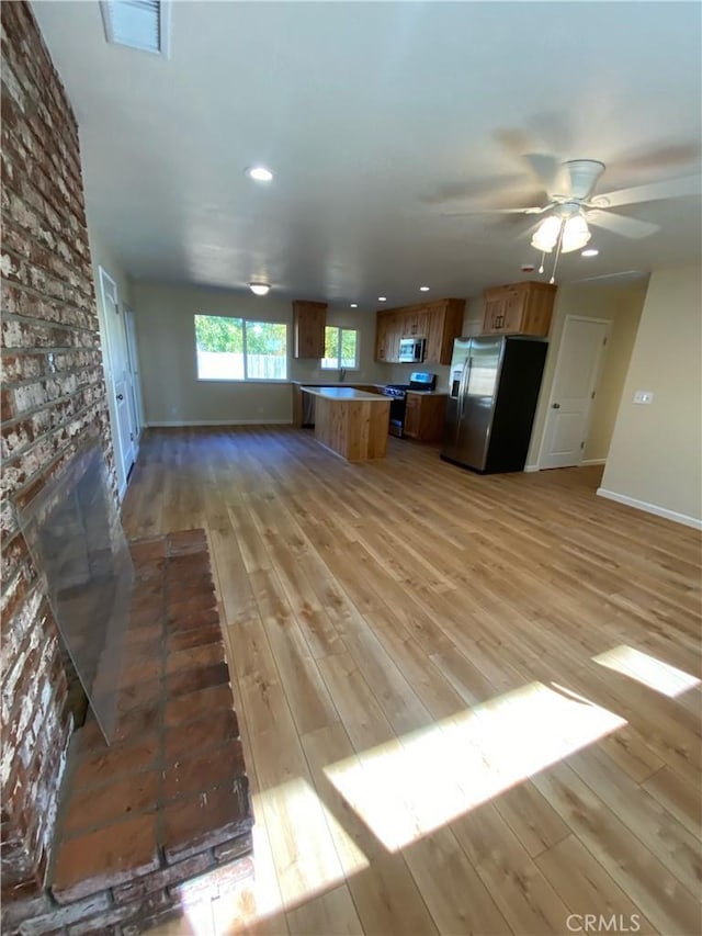1954 Durham Dayton, Durham, CA 95938 - kitchen featuring appliances with stainless steel finishes, open floor plan, light wood finished floors, recessed lighting, and a ceiling fan
