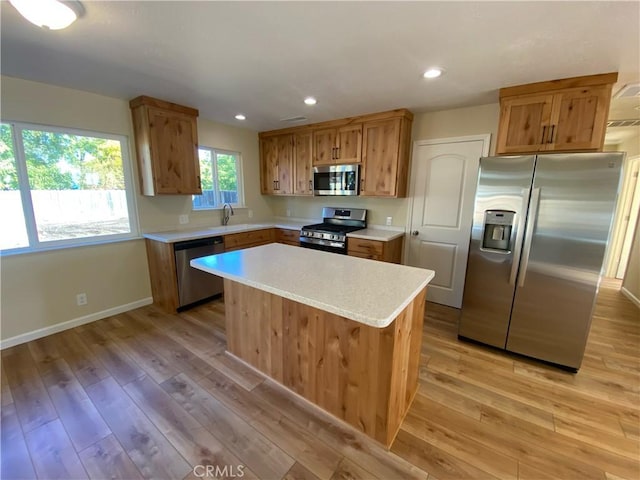 1954 Durham Dayton, Durham, CA 95938 - kitchen with appliances with stainless steel finishes, light countertops, light wood finished floors, a center island, and recessed lighting