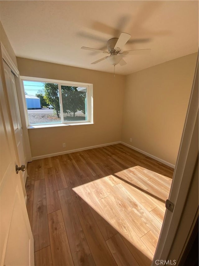 empty room featuring ceiling fan and wood-type flooring