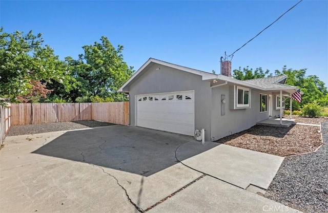 1954 Durham Dayton, Durham, CA 95938 - view of side of home with a chimney, a garage, stucco siding, and driveway