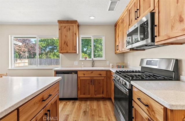 1954 Durham Dayton, Durham, CA 95938 - kitchen with stainless steel appliances, light wood-style flooring, light countertops, recessed lighting, and brown cabinets