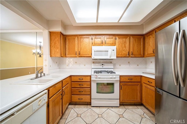 kitchen with tasteful backsplash, crown molding, white appliances, and a notable chandelier