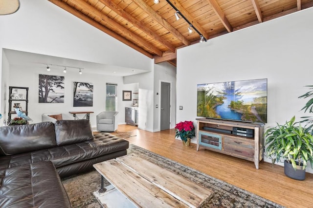 living room with wooden ceiling, rail lighting, hardwood / wood-style flooring, and high vaulted ceiling