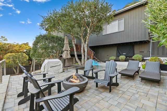 view of patio / terrace featuring an outdoor fire pit