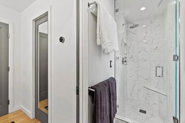 bathroom with walk in shower and hardwood / wood-style flooring