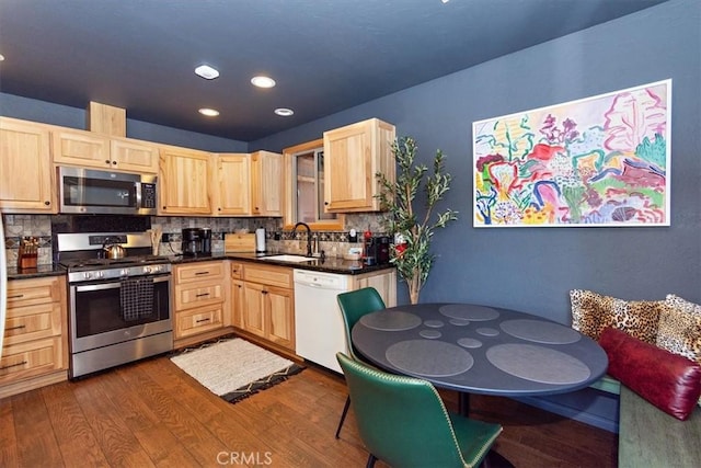 kitchen with backsplash, light brown cabinets, sink, and stainless steel appliances