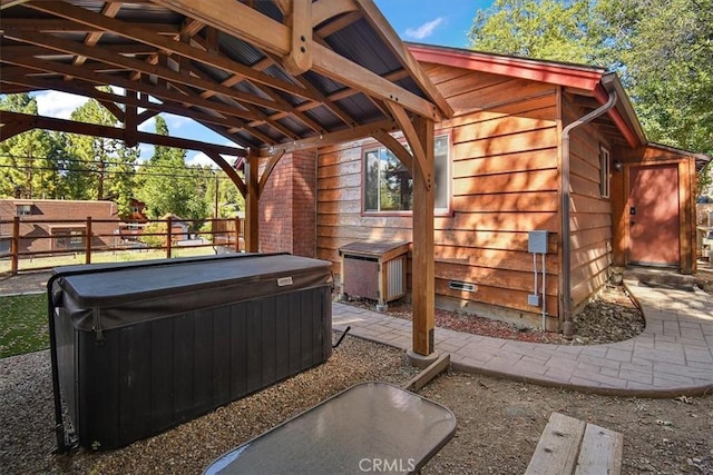 view of patio / terrace with a hot tub