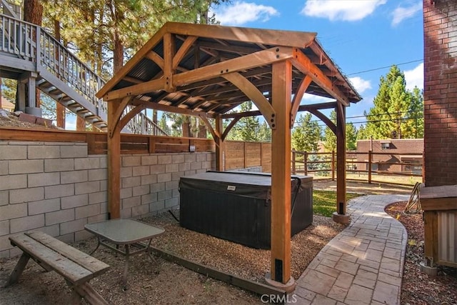 view of patio / terrace with a gazebo and a hot tub