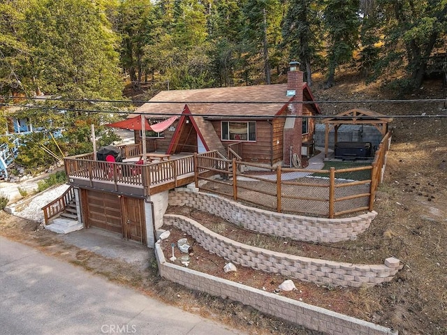 view of front of home featuring a garage and a deck