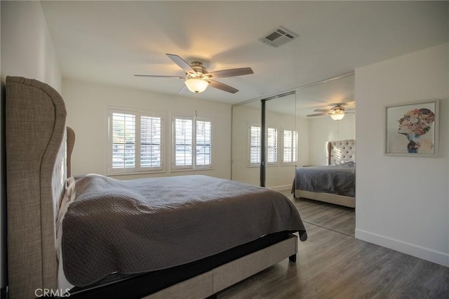 bedroom featuring a closet, ceiling fan, and dark hardwood / wood-style flooring