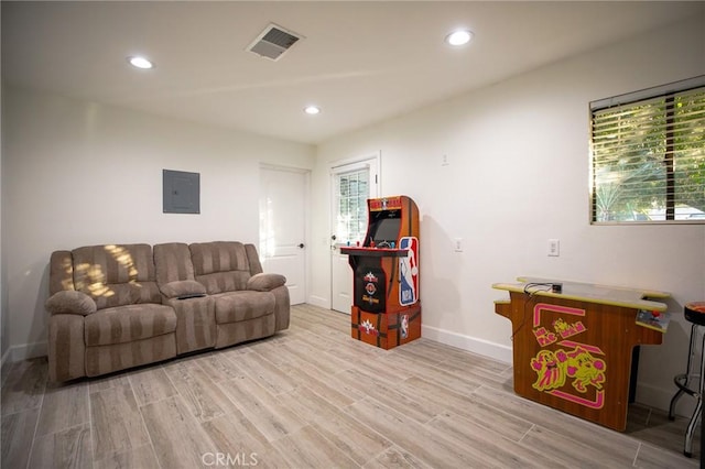 living room featuring light wood-type flooring and electric panel