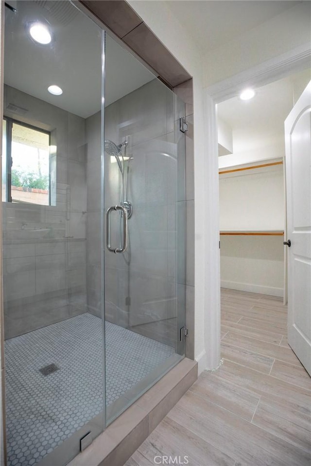 bathroom with a shower with door