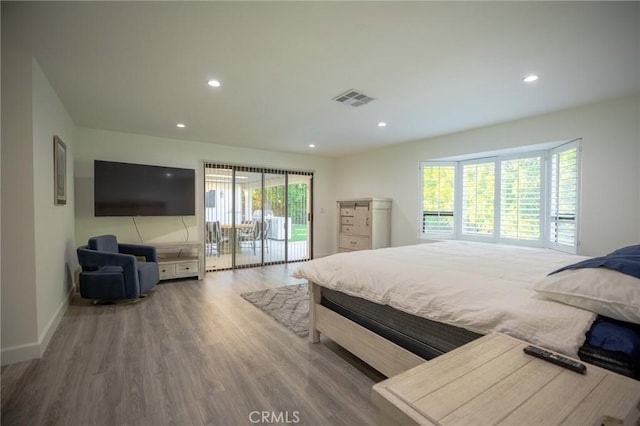 bedroom featuring access to exterior and wood-type flooring