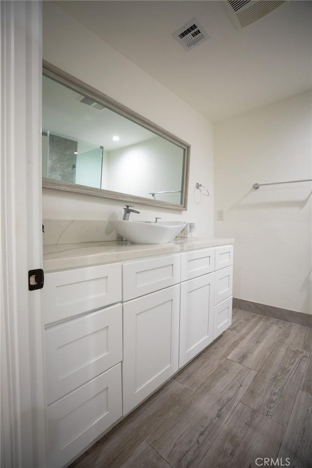 bathroom featuring hardwood / wood-style floors and vanity